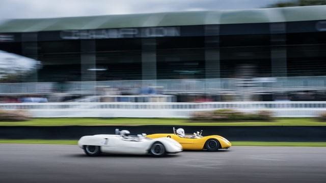 Two cars racing at Goodwood Revival